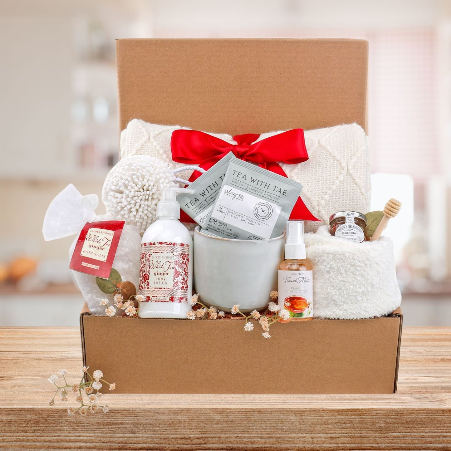 Gift basket with products and a red bow on a wooden surface