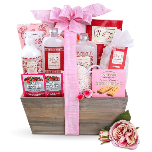 Gift basket with bath products, tea, and cookies on a white background