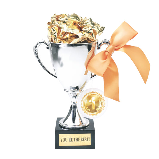 Silver trophy with gold candy and ribbon on a white background