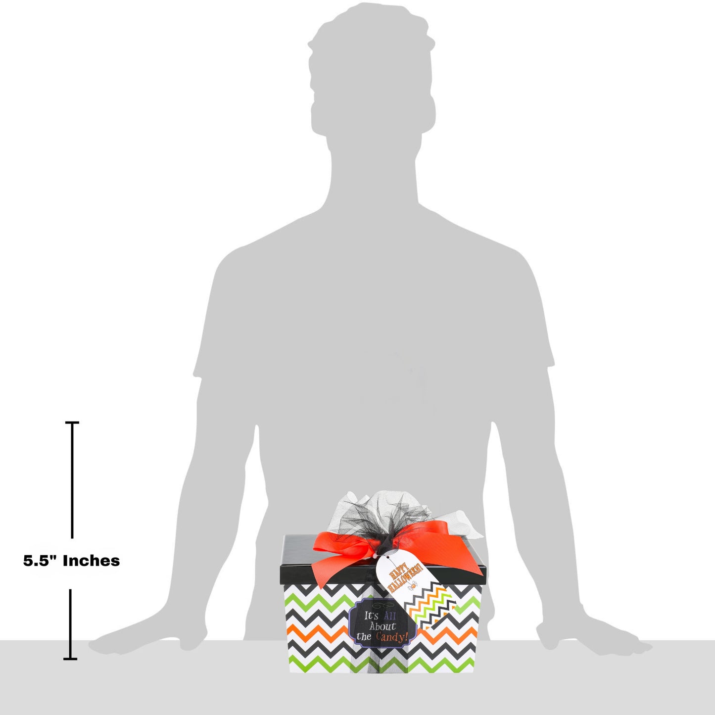 A gift box with a black, white, orange, and green chevron pattern, tied with a bright orange ribbon and a white tag, shown in front of a gray silhouette of a person. A vertical measurement marker on the left indicates 5.