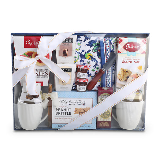 Gift set with mugs, snacks, and a knife in a decorative box.