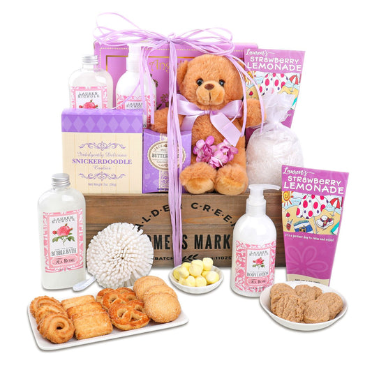 Gift basket with teddy bear, cookies, and bath products on a white background