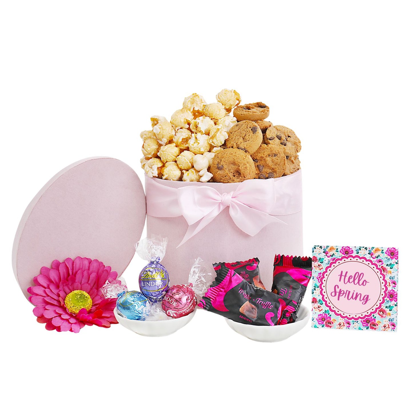 Gift basket with cookies, popcorn, candies, and a pink card on a white background