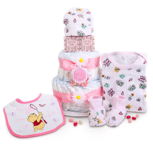 Baby gift set with diaper cake, bib, booties, and hat on a white background