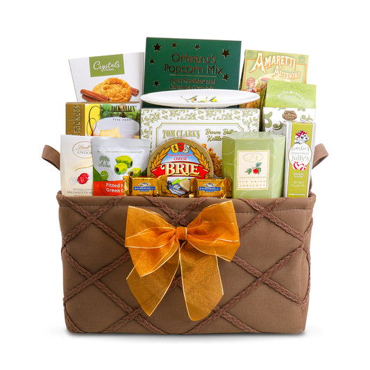 Gift basket with a brown woven design and gold bow, containing various food items on a white background.
