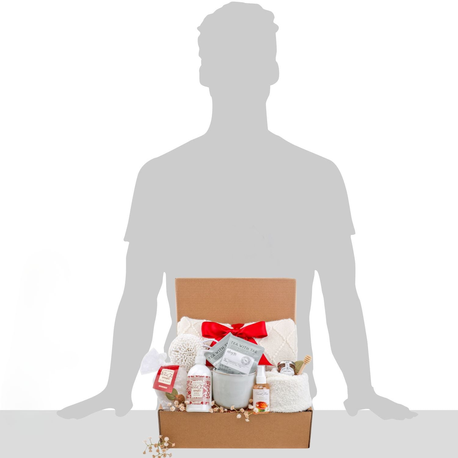 Gift basket with various items on a silhouette of a person against a white background