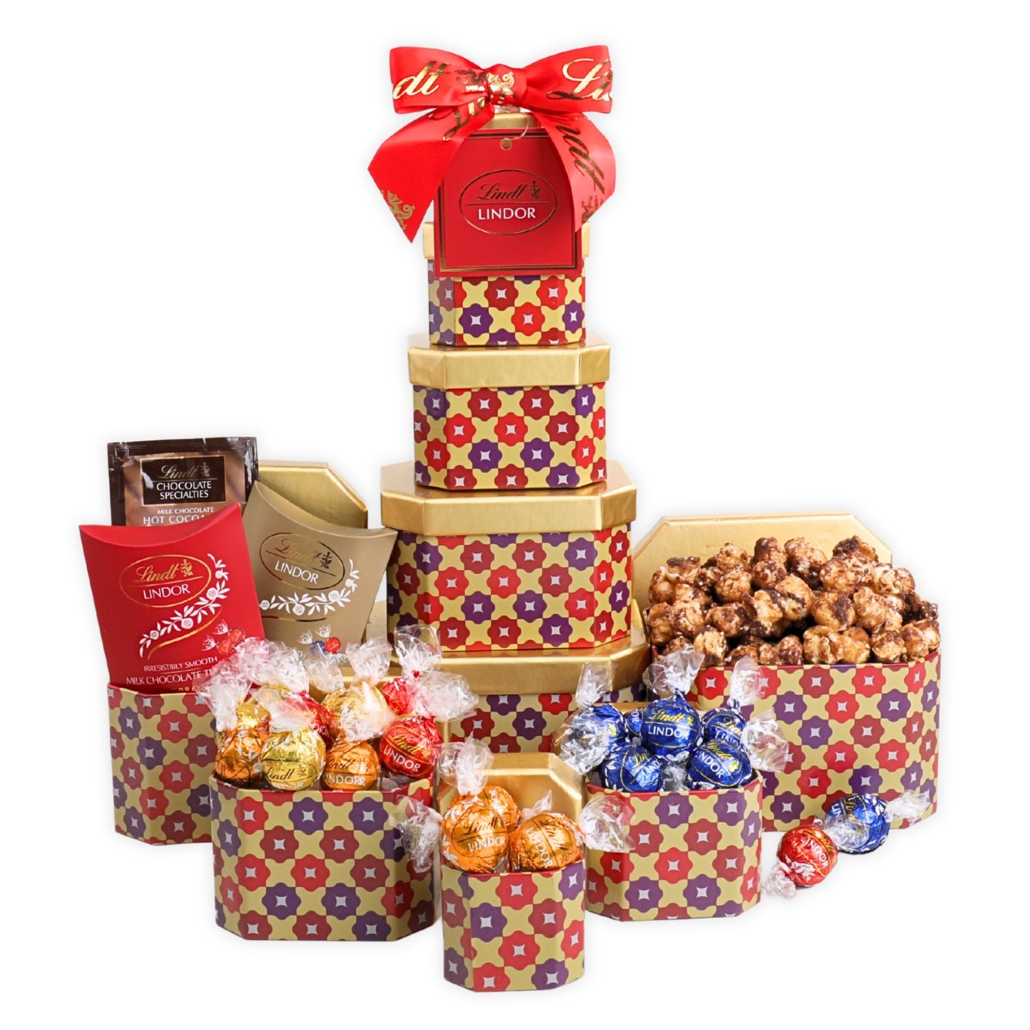 Decorative gift tower with Lindor chocolate, popcorn, and other treats on a white background