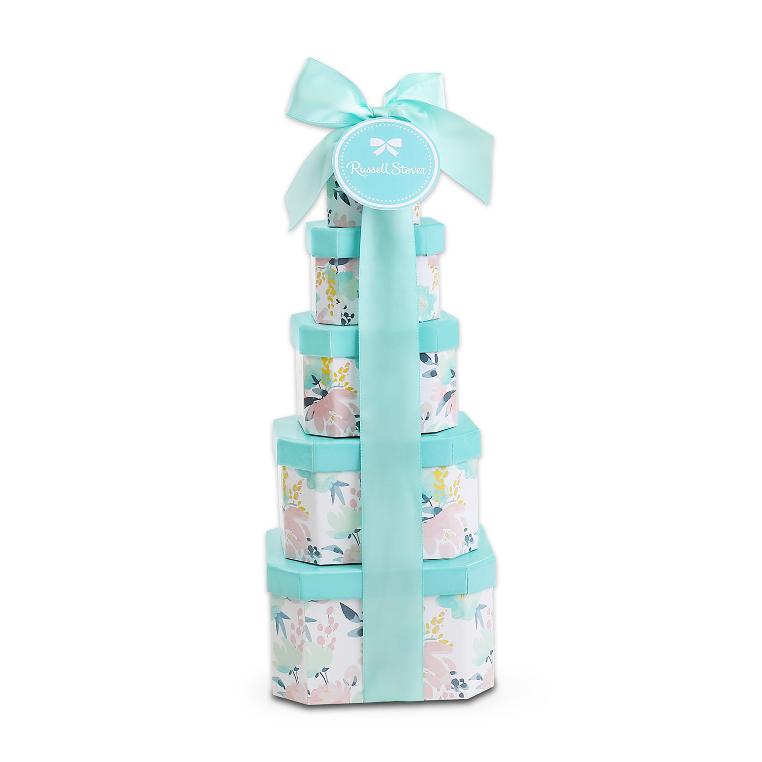Stack of floral-patterned gift boxes tied with a blue ribbon on a white background
