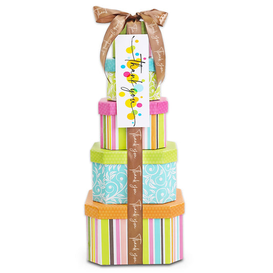 Stack of colorful gift boxes with a ribbon and decorative tag on a white background