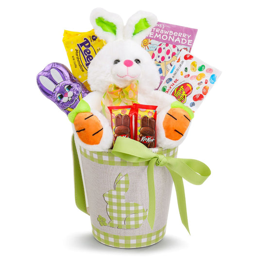 Easter gift basket with plush bunny, candy, and snacks on a white background