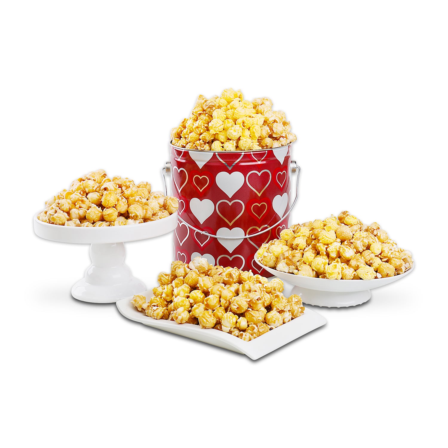 Popcorn tin with contents displayed on white display dishes