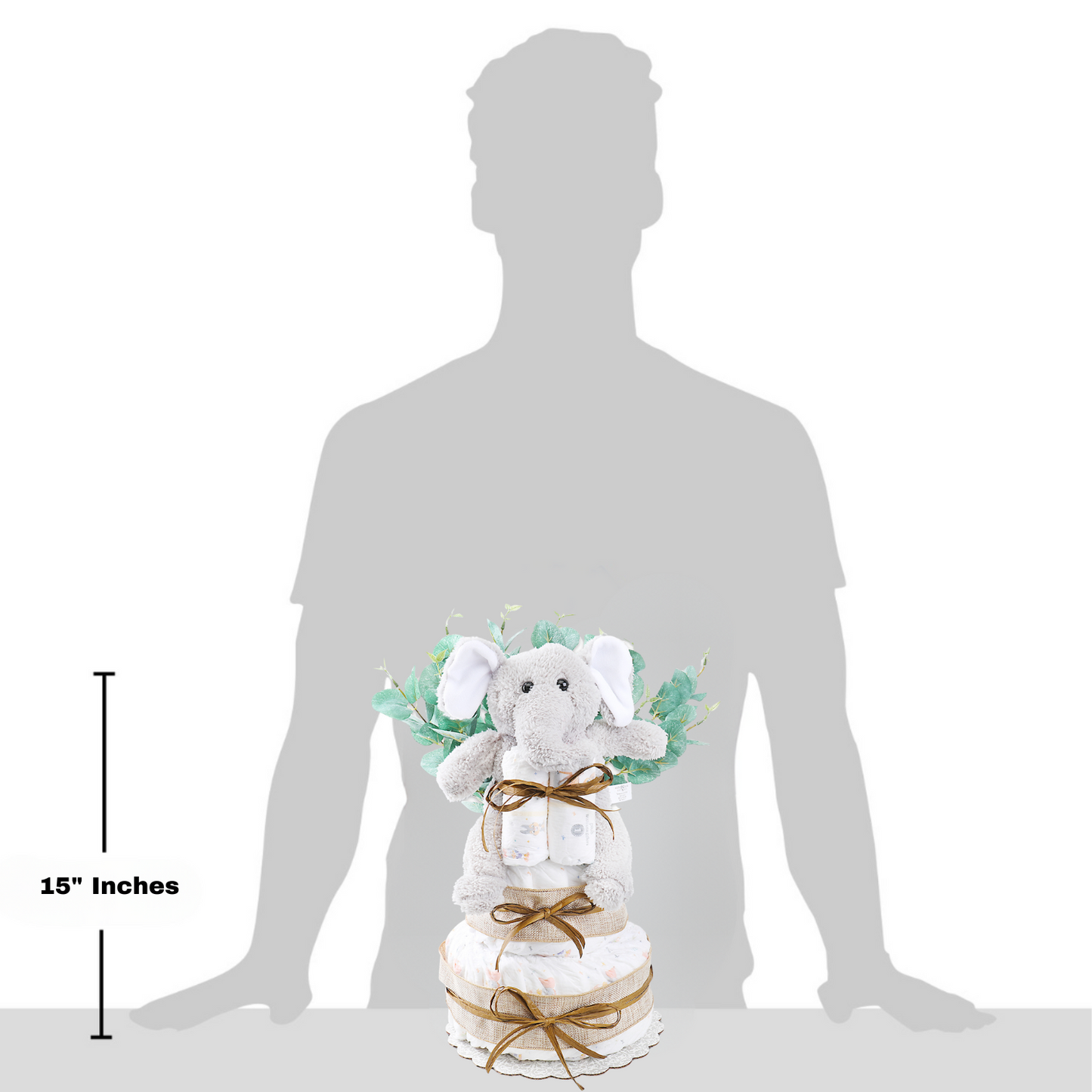 Stuffed elephant toy with a diaper cake and measurements against a silhouette of a person.