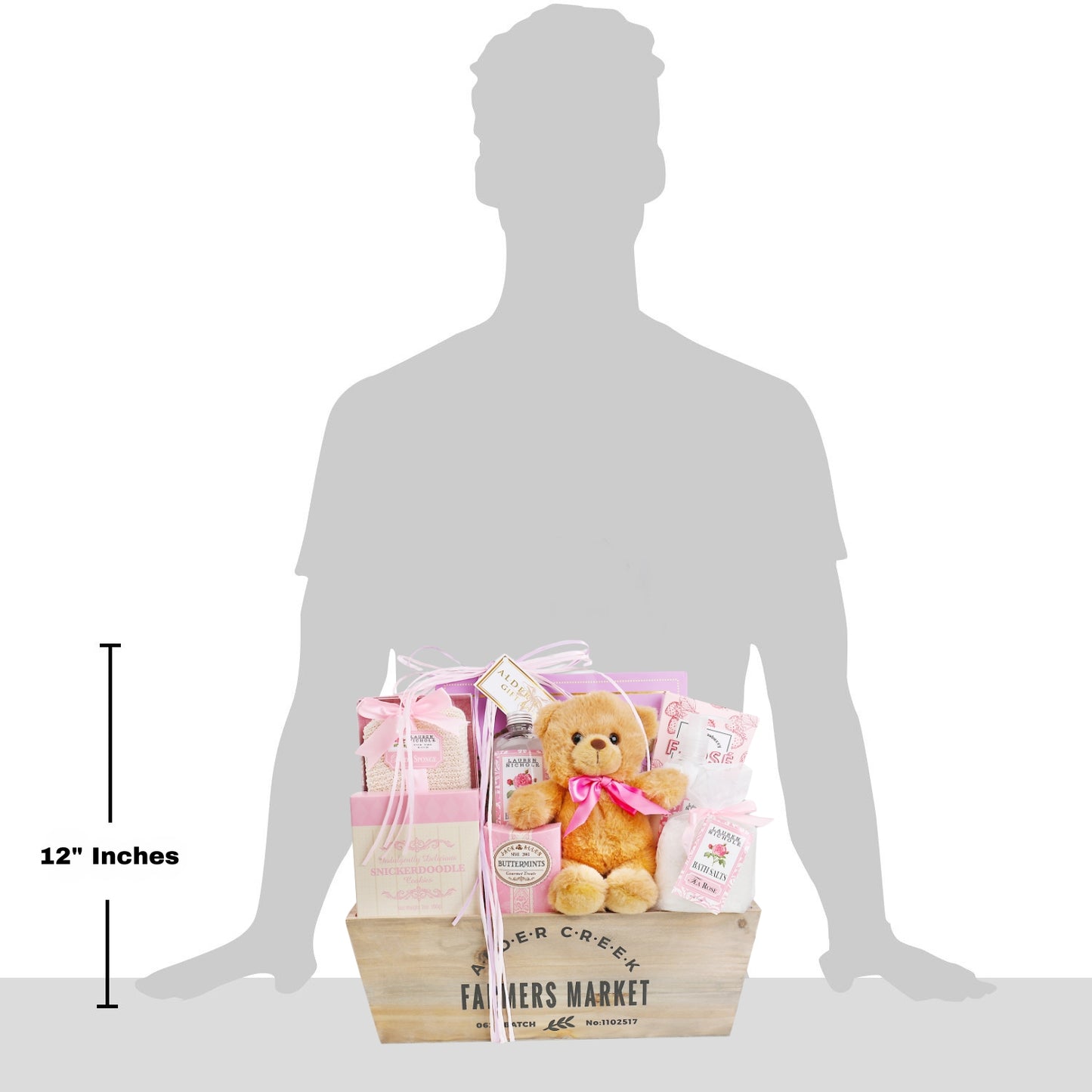 Gift basket with teddy bear and products on a silhouette of a person, showing its size.
