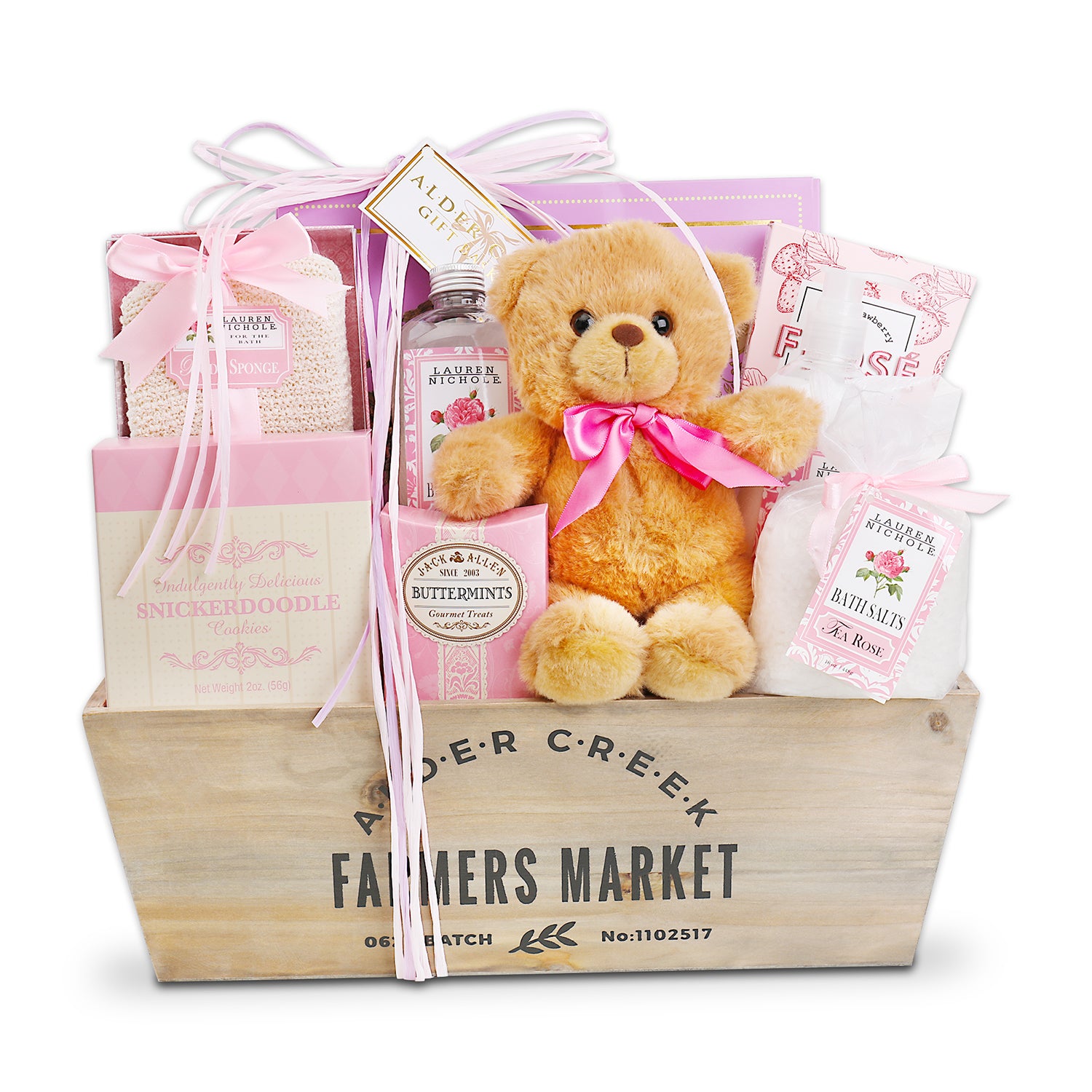 Gift basket with teddy bear, bath products, and snacks in a wooden crate labeled 'Alder Creek Farmers Market'.