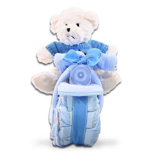 White teddy bear with blue outfit and diaper stack on a white background