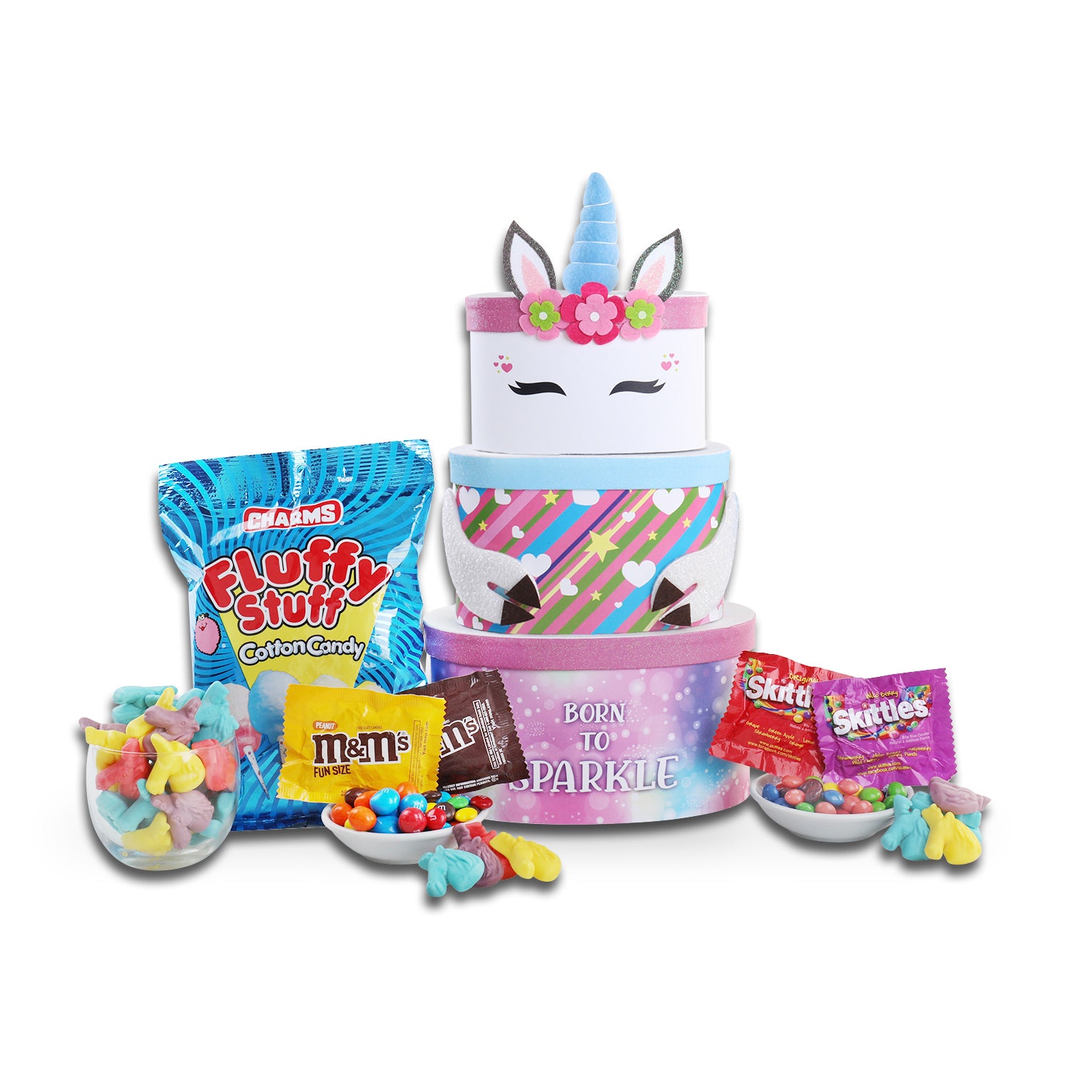 Unicorn-themed candy tower with various candies and a bag of Fluffy Stuff cotton candy on a white background.