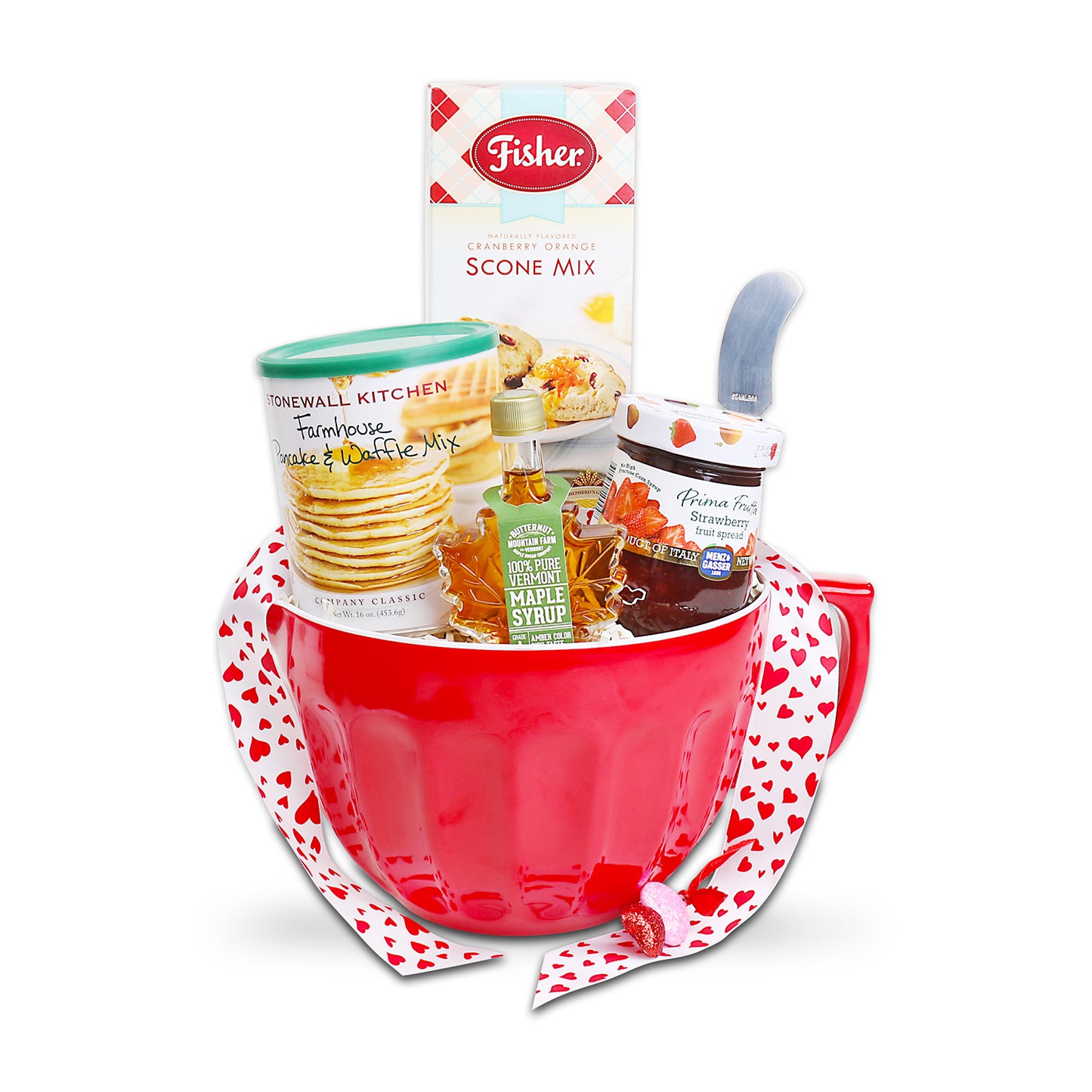Red mixing bowl with heart pattern ribbon, Fisher scone mix box, and other baking items on a white background