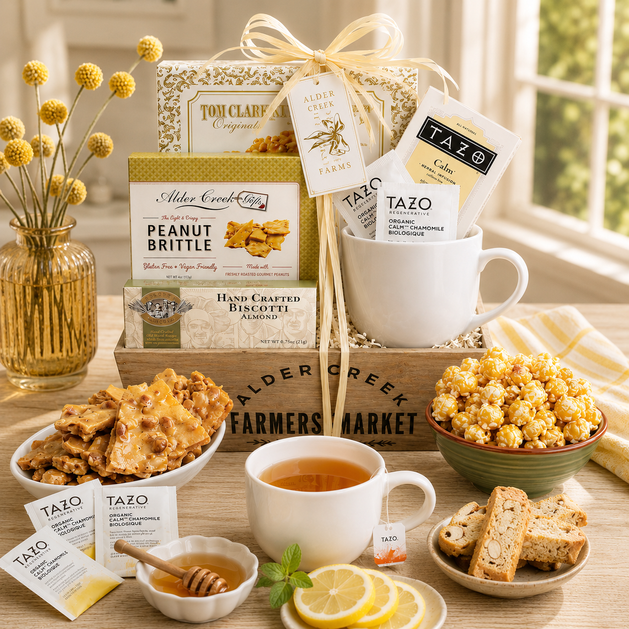 Gourmet gift basket with tea, snacks, and a mug on a wooden table.