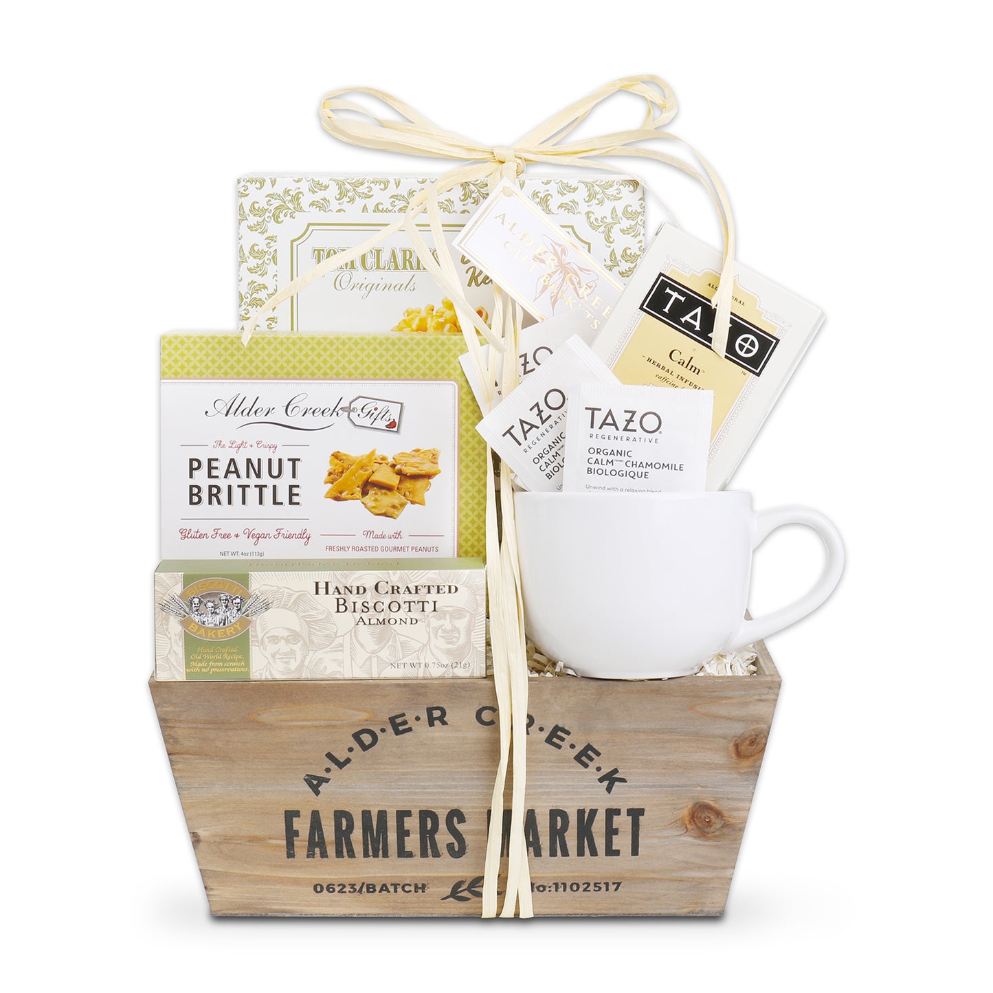 Gift basket with a cup, snacks, and tea from Alder Creek Farmers Market on a white background