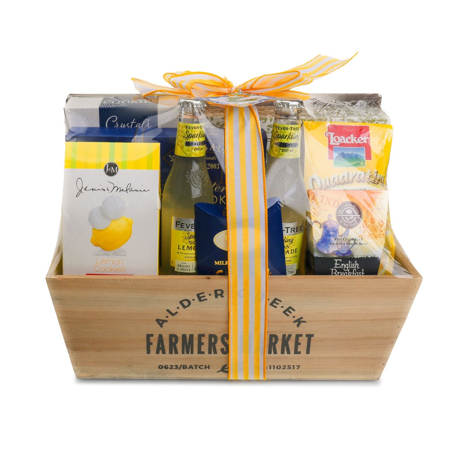 Gift basket with Alder Creek Farmers Market branding, featuring a variety of products including a bottle of lemonade and packaged goods.