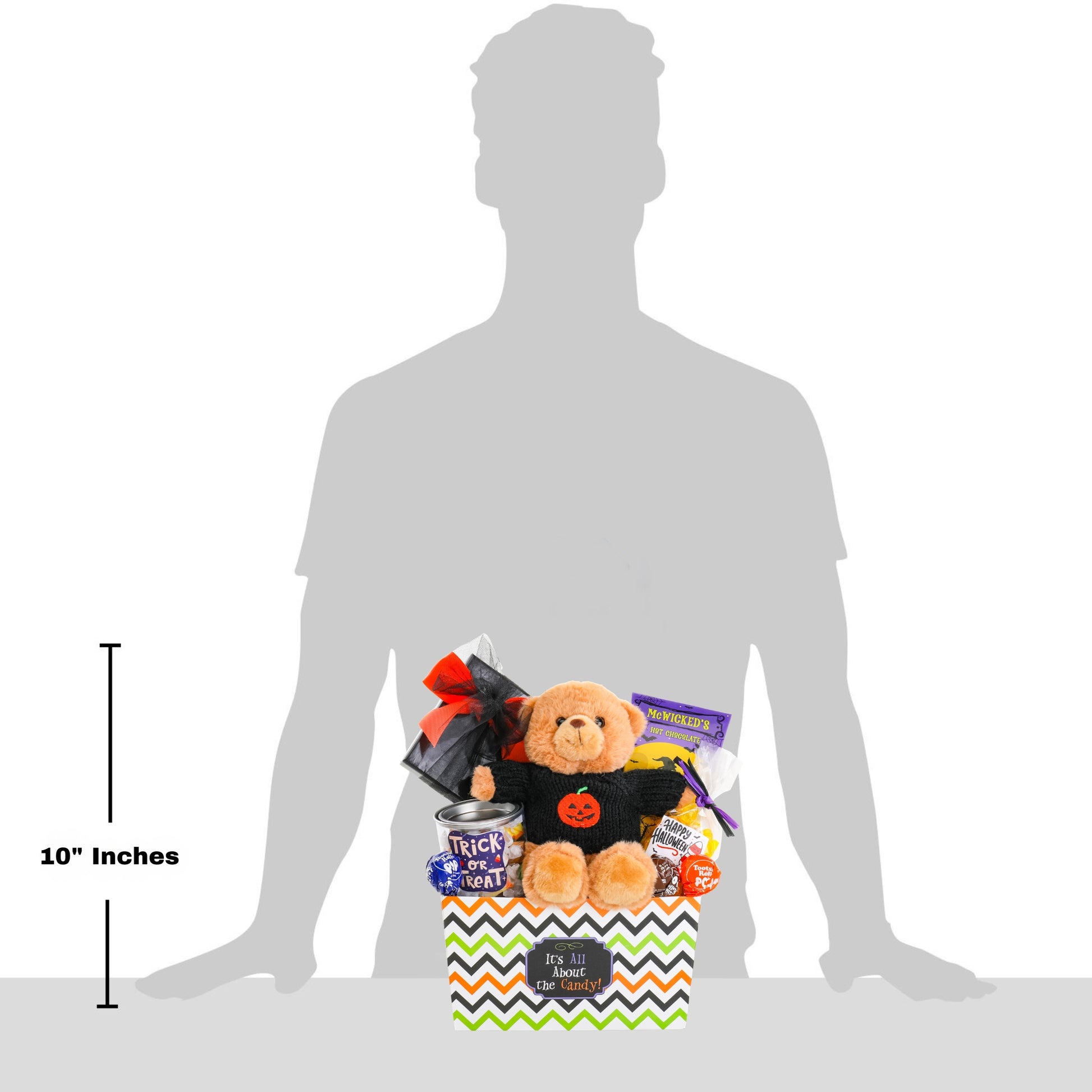A Halloween-themed teddy bear gift basket displayed in front of a large gray silhouette of a person, with a 10-inch height marker on the left. 