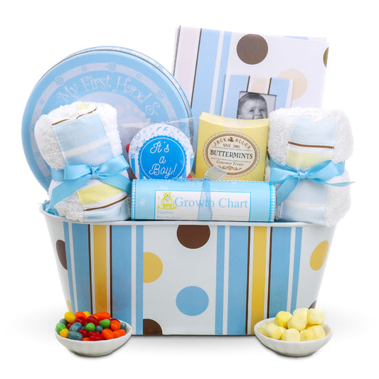 Baby gift basket with baby items and snacks on a white background